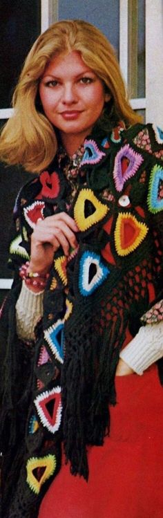 a woman wearing a colorful crochet shawl