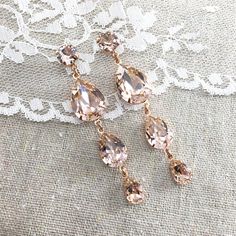 "Heatherly Designs signature teardrops have been kicked up a few glam notches with these extra long dangling shoulder duster earrings made with genuine Swarovski® crystals in blush pink which are set in plated brass. The posts are hypoallergenic surgical steel. ●Nickel free ●Size (Length): 2.75\" or 7cm ●Swarovski crystal color(s): Vintage Rose ●Arrives in our signature Heatherly gift box. Handmade with ❤ by Heather ● ● ● ● ● ● ● ● ● ● ● ● ● ● ● ● ● ● ● ● ● ● ● ● ● ● ● ● →Quantity Discounts list Rose Gold Wedding Earrings, Rose Gold Dangle Earrings, Rose Gold Earrings Wedding, Gold Wedding Earrings, Rose Gold Bridal Earrings, Extra Long Earrings, Rose Gold Drop Earrings, Morganite Earrings, Blush Earrings