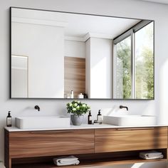 a bathroom with two sinks and a large mirror