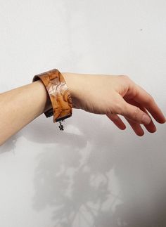 "Leather cuff bracelet in medium light brown color made with embossed floral design ( please note this is machine tooled/embossed up-cycled leather). It is double sided, so you can wear it both ways: with rose pattern up or with the dark brown side Adjustable length: For S / M wrist sizes - up to 7\" wrist size Max Length: 8\" with clasp and extension chain (6.5\" leather strap) 1\" wide   ♣ Checkout other LEATHER bracelets in my shop: https://etsy.me/2LeZ4Yp ♥ Please read my shop policies befor Brown Bangle With Bracelet Strap, Brown Strap Style Bangle, Brown Cuff Bracelet For Festival, Brown Cuff Bracelet For Festivals, Brown Festival Cuff Bracelet, Bohemian Brown Wristlet For Gift, Adjustable Brown Bohemian Bangle, Unique Brown Festival Bracelets, Handmade Bohemian Brown Wristband