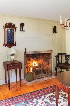 a living room filled with furniture and a fire place in the middle of the room