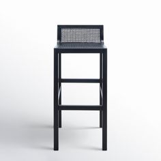 a black stool sitting on top of a white floor