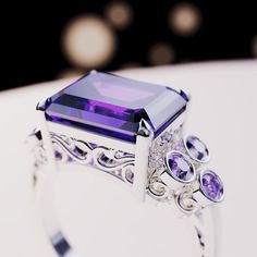 Introducing The Violet Love: This bold statement ring is perfect for any occassion. As a gift for her, a wedding ring or a gift for yourself - because you deserve it - it is guaranteed to impress. This ring is made as a 3-in-1 triple ring set. 2 perfectly fitting bands to complement the big bold center main ring. A bold and beautiful simulated amethyst sits like a crown in the center of a gemstone halo. The sides covered with beautiful simulated diamonds and purple enamel. Underneath you have pr Silver Amethyst Ring For Valentine's Day Gift, Cubic Zirconia Rings For Mother's Day Gift, Luxury Purple Jewelry Gift, Silver Ring For Formal Occasions And Mother's Day, Silver Ring For Formal Occasions On Mother's Day, Elegant Emerald Cut Jewelry As A Gift, Elegant Emerald Cut Jewelry For Gifts, Exquisite Cubic Zirconia Ring As A Gift, Luxury Purple Ring As A Gift