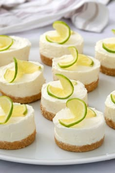 mini margarita cheesecakes on a white plate with lime slices around the top and bottom