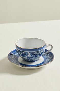 a cup and saucer sitting on top of a table