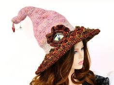 A renfair costume, witch festival, dragon cosplay, dragon event, gaming, or you're just a dragon lover - This beaded dragon eye witch hat is soft, comfortable, and unique. I've made this hat to be soft to wear and firm enough to stand on its own. The body is a blend of mohair and wool, in felted crochet. Ive added a wire high inside towards the tip and a touch of stuffing for ultimate shaping and adjusting ability. I've crocheted the brim in colorful dragon scales, all the way to the wired edge. Each scale is hand beaded with a gold bead at the tip of the scale. The large eye is 3 dimensional, with faux leather lids and a crocheted frill. A golden trim enameled seashell and charm dangle from the tip for the unusual treasures being collected. The felted crochet body allows for a soft stretc Whimsical High Crown Hats For Costume Party, Fantasy High Crown Costume Accessories For Halloween, Fantasy High Crown Costume Hats For Cosplay, Fantasy High Crown Halloween Costume Accessories, High Crown Costume Hats For Halloween Cosplay, Whimsical High Crown Costume Hat, High Crown Costume Hats For Cosplay Halloween, Halloween Cosplay Costume Hat With High Crown, Handmade Gothic Costume Hats And Headpieces For Parties