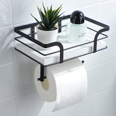 a toilet paper holder with two rolls of toilet paper and a succulent plant