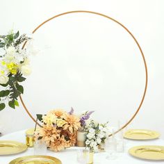 a white table topped with plates and flowers