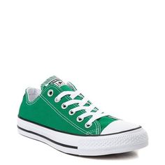 green converse sneakers with white laces on them