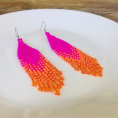 Enjoy the summer wearing these bright fuschia seed bead earrings. For these pageant handwoven earrings, I was inspired by the tribal style. These aesthetic waterfall earrings are made with gradient pattern in hot pinks and orange colors. These magenta ombre earrings are making the perfect gift for anybody who loves long beaded earrings or who's looking for eye-catching evening earrings. Check out the selection of fringe bead earrings in my Etsy shop 'JewelryByJullia'. 100% top quality handmade earrings.  Length: 3.94'' / 10 cm Width: 0.79'' / 2 cm Materials:  - Czech seed beads - stainless steel accessories. The real color of the item may be slightly different from the picture shown on website caused by the brightness of your monitor. If you have special size requirements, please send me a Hot Pink Beaded Earrings, Pink Orange Gradient, Aesthetic Waterfall, Fringe Bead Earrings, Handwoven Earrings, Waterfall Earrings, Evening Earrings, Orange Gradient, Gradient Pattern