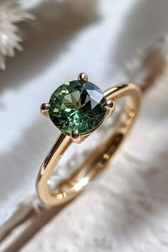 Experience the allure of ethical and sustainable jewelry design with our Green Sapphire Solitaire ring. This captivating piece, with its vibrant green sapphire at its heart, is more than just jewelry - it's a statement about your commitment to a greener future. Say 'yes' to sustainability and 'I do' to the Green Sapphire Solitaire engagement ring. Blue Solitaire Engagement Ring, Parti Sapphire, Green Sapphire Solitaire Ring, Green Rings Engagement, Wedding Rings Green, Emerald Engagement Ring Vintage, Green Engagement Ring, Green Engagement Rings, Green Sapphire Engagement