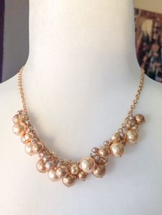 "Beautiful shades of gold pearls are arranged haphazardly along a gold filled chain.  Among the pearls are gold toned rhinestone balls to add a little sparkle to your neckline.  A stunning classic necklace to add to your wardrobe. ::Details:: Pearl neckline is 5\" long Necklace length is 17\" Chain, lobster clasp and wire are gold filled All jewelry purchased comes inside a box and tied with a ribbon.  Ready for gift giving or to treat yourself. For previews and musings, follow me on instagram @bellaluandme Thank you for shopping handmade! http://www.etsy.com/shop/BellaLuAndMe" Elegant Gold Pearl Necklace With Gold Beads, Gold Beaded Pearl Necklace For Formal Occasions, Gold Pearl Necklace With Dangling Beads For Wedding, Wedding Gold Pearl Necklace With Dangling Beads, Gold Pearl Necklaces With Dangling Beads, Gold Pearl Jewelry With Dangling Beads, Glamorous Gold Pearl Necklace, Glamorous Gold Pearl Necklace For Party, Gold Pearl Costume Jewelry Necklace