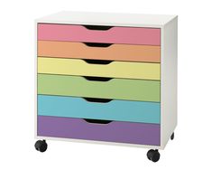 a multicolored dresser with wheels on the front and bottom drawers in different colors