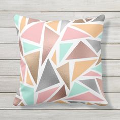 a decorative pillow with an abstract design on the front and sides, in pastel colors