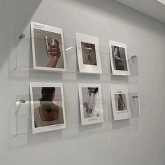 a wall with pictures on it and a glass hanging from the ceiling in front of them