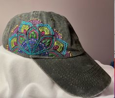 a gray hat with colorful embroidered designs on it