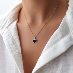 This elegant black heart necklace is crafted with 14k solid gold, embodying timeless beauty and sophistication. Its minimalist design, combined with the finest craftsmanship, makes it a perfect piece for everyday wear or a meaningful gift for a loved one. This necklace is crafted with real 14k solid gold(not plated, not vermeil, not gold filled) You don't need to worry about water, perfume or conditioner contact since real gold doesn't tarnish. The center is hand applied black enamel on top of solid gold for the design purpose, hot applied enamel is the best and most resistant type of application in which enamel and gold bond together over extreme temperatures. This ensures that your piece keeps its beauty for decades to come. You can even wear this piece in water as well. Black Necklaces For Anniversary On Valentine's Day, Black Necklace For Anniversary On Valentine's Day, Valentine's Day Black Necklace For Anniversary, Minimalist 14k Gold Necklace With Heart Charm, Minimalist Tarnish Resistant Heart Pendant Jewelry, Minimalist Tarnish-resistant Heart Pendant Jewelry, Black Enamel 14k Gold Necklace, Minimalist 14k Gold Double Heart Necklace, Black Enamel Heart Pendant Jewelry