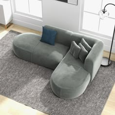 a large gray couch sitting on top of a rug