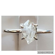 a white diamond ring sitting on top of a table