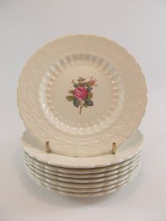 a stack of white plates sitting on top of each other in front of a white background