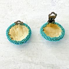 Vintage Peyote Stitch Round Seed Beads Stud Clip On Earrings - Southwestern and likely Native American, these beautiful peyote stitch round clip on earrings are unsigned. They are turquoise with a starburst of black and white seed beads. The overall form is slightly domed. The seed beads are attached one by one, by hand, to a deerskin leather background. The clips are silver-tone. The earrings measure 1 1/16 inches in diameter. The condition is excellent with minor wear to the back of the earrin Leather Background, Jewelry Tags, Deer Skin, Bezel Diamond, Vintage Costume Jewelry, Vintage Costumes, Gold Watch, Clip On, Clip On Earrings