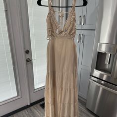 a dress hanging on a rack in a kitchen