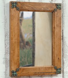 a mirror hanging on the side of a wooden wall