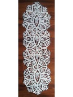 white crocheted doily on wooden floor