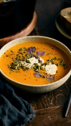 a bowl of soup on a wooden table