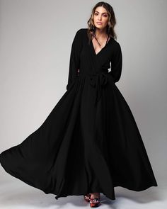 This 70's inspired maxi dress features a sexy cross front V-shaped surplice neckline. The elasticized waist adjusts to fit a range of sizes and has an attached self-tying belt at the right-hand side seam. The cuffed bell sleeves add a hint of retro glamour. The opaque fabric has a butter-soft hand with gorgeous, vibrant hues. The full, sweeping circle mid-length skirt is perfect for making a dramatic entrance to any event. The skirt is partially lined. ** Based on the settings of your display, c Circle Maxi Skirt, Concert Dress, Dramatic Entrance, Queen Outfits, Retro Glamour, Dress Better, Goth Wedding, Black Slip Dress, Fashion District