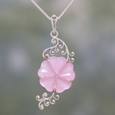 An elegant, pink flower is hand-carved from a stone of dyed quartz, hanging at the center of a length of box chain. India's Shubhra Singh designs this wonderful pendant necklace, crafted with curling sterling silver vines by local artisans. Pink Sterling Silver Flower-shaped Jewelry, Pink Jade Jewelry With Natural Stones, Pink Jade Jewelry Gift, Pink Jade Jewelry As A Gift, Pink Jade Jewelry For Gift, Elegant Pink Jewelry With Engraving, Elegant Pink Engraved Jewelry, Elegant Engraved Pink Jewelry, Pink Gemstone Flower-shaped Jewelry