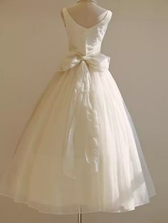 a white dress with a bow on the back