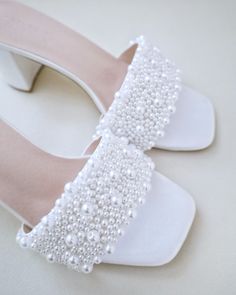 "Classic satin slip on block heel sandals adorned with allover pearls on the vamp for romantic, elegant and feminine look. The delicate pearl beads are placed to create a graceful classic style. Simple and easy wear for bridal wear, bridesmaids, holiday party, wedding parties, and any special occasions.  DETAILS: HEEL HEIGHT: 2.5 Inches COLORS AVAILABLE: Ivory and White UPPER: Synthetic upper and lining MATERIALS: Manmade outsole STYLE NAME: VERONA Not sure of which size to purchase? Shoes measurements are as follow: (Please note measurements taken the length of inside of shoe from toe to heel) Size 5.5 - 9\" Size 6 - 9.25\" Size 6.5 - 9.375\" Size 7 - 9.5\" Size 7.5 - 9.625\" Size 8 - 9.75\" Size 8.5 - 9.875\" Size 9 - 10.125\" Size 10 - 10.375\" Size 11 - 10.75\" - We DO NOT offer refund Pearl Open Toe Wedding Shoes For Formal Occasions, Evening Closed Toe Pearl Wedding Shoes, Evening Wedding Shoes With Pearl And Closed Toe, Formal Open Toe Pearl Wedding Shoes, Formal Pearl Open Toe Wedding Shoes, Pearl Embellished Heels For Wedding Guest, Summer Wedding Pearl Heels, Elegant Open Toe Pearl Wedding Shoes, Elegant Pearl Embellished Open Toe Wedding Shoes