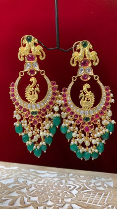 Premium quality High gold plated, pearl work, hand carved work , AD lining and kundan work. Clip back. about 5.5 inch long Absolute designer piece and statement earring. Multicolor Kundan Bridal Earrings With Intricate Design, Multicolor Heavy Chandbali Bridal Earrings, Multicolor Temple Jewelry Chandbalis With Tilla, Multicolor Chandbalis With Tilla In Temple Jewelry Style, Multicolor Kundan Chandbalis With Intricate Design, Multicolor Chandbali Bridal Earrings In Temple Jewelry Style, Multicolor Kundan Danglers With Intricate Design, Multicolor Chandbali Bollywood Bridal Earrings, Multicolor Chandbali Bridal Earrings For Celebration