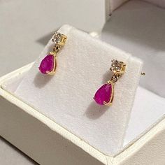 Give your loved one the ultimate gift, a pair of classic genuine Ruby set earrings set within UK hallmarked 9ct Yellow Gold.  A dainty classic design, little drops, just stunning! RUBY & SAPPHIRE are available for 2-3 days delivery ... we are busy making further pairs using our other gemstones... those will take a few weeks i'm afraid. Metal: Solid 9ct Yellow Gold ( Fully Hallmarked )   Info: Nickel Free Stone: Genuine Red Ruby, Pear Cut & Simulated Diamond Free Gift: Jewellery Polishing Cloth Quantity: Sold as a pair Type: Specifically designed for the lobe Size: Total length 12mm  Fixing: 9ct Hallmarked Gold Butterfly Backs  Colour: Ruby Red / Pink NOTE: In general due to health & safety reasons, earrings are non returnable unless there is a description error, or have incurred damage in Ruby Anniversary, Ruby Set, Jewelry Ruby, Gold Jewelry Simple Necklace, Set Earrings, Gold Jewelry Simple, Victorian Design, Diamond Free, India Jewelry