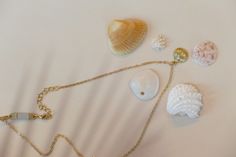 Embrace the beauty of the sea with the Summer Ocean’s Shell Necklace. This enchanting piece features a finely detailed shell pendant, perfect for adding a touch of ocean-inspired elegance to any outfit. Ideal for both casual beach days and sophisticated summer evenings, this necklace brings the serenity of the ocean to your wardrobe. Details Alloy material 14.5” chain , 2” extension extender option and a 1” dainty diffuser extender. Dainty diffuser for diffusing essential oils which can be removed if desired. Unique faux suede material will diffuse essential oils for hours. Wipe your necklace clean after wearing to preserve the life of your jewelry. Please keep dry and remove when bathing or swimming. Elegant Starfish Charm Jewelry For Vacation, Ocean-inspired Pearl Pendant Jewelry, Ocean-inspired Shell-shaped Pearl Pendant Jewelry, Ocean-inspired Strand Necklace With Starfish Charm, Dainty Clavicle Chain Necklace For Beach, Ocean-inspired Jewelry With Starfish Charm And Shell Shape, Ocean-inspired Shell Necklace With Pearl Charm, Ocean-inspired Necklaces For Summer Gifts, Ocean-inspired Strand Necklaces For Jewelry Making