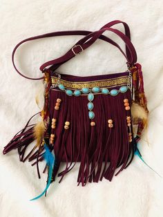 Dreamy bohemian feathers, charms and beads bag 💕 Deep burgundy with pendant turquoise colored metallic charm attached with vintage 1980s sari ribbon in front of bag. Vintage Sari strips are affixed to the sides of this cute purse and next to it are handmade feather charms in lovely beige and deep aqua blue feathers dangle from the sides. They match the pendant turquoise charm on the front.  cute one of a kind, fringe crossbody bag, beautiful deep burgundy color perfect for autumn outings, origi Beads Bag, Blue Feathers, Sari Ribbon, Fringe Crossbody Bag, Turquoise Charm, Cute Purse, Dark Burgundy, Vintage Sari, Fringe Bags