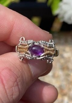 This size 7 ring features a stunning amethyst and peridot gemstone with an intricate pattern woven along the band. Spun in .925 silver and 14k yellow gold fill wire. Includes complimentary polishing pad and gift box. Gold Amethyst Wire Wrapped Jewelry, Artisan Purple Gemstone Jewelry, Spiritual Wire Wrapped Sterling Silver Jewelry, Handmade Oval Dainty Jewelry, Purple Wire Wrapped Metal Jewelry, Unique Wire Wrapped Sterling Silver Jewelry, Unique Adjustable Purple Jewelry, Purple Gemstone Metal Jewelry, Unique Wire Wrapped Jewelry Ring