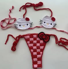 two crocheted hello kitty swimsuits with bows and bow ties attached to them