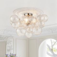 a chandelier hanging from the ceiling in a white room