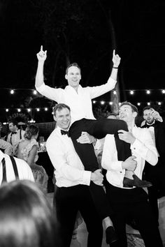 two men in tuxedos are on the shoulders of another man at a party