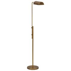 a brass floor lamp with an arm