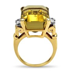 Capture the essence of the Retro Mid-Century era with this exquisite 14kt Yellow Gold Citrine and Diamond Cocktail Ring. At its center, you'll find a magnificent emerald step-cut citrine, an impressive 16.6 carats in weight, held securely in a four-prong basket setting. The citrine's dimensions of 19.68 x 13.18 x 9.68 mm are a testament to its grandeur.This striking citrine is beautifully complemented by four full-cut diamonds, adding a touch of elegance and sparkle to the design. The total diam Luxury Gold Emerald Ring For Formal Occasions, Elegant Octagon Topaz Ring With Center Stone, Classic Yellow Gold Topaz Ring With Gemstone Accents, Gold Emerald Cut Ring With Gemstone Accents, Elegant Polished Topaz Ring For Formal Occasions, Classic Yellow Topaz Ring For Formal Occasions, Elegant Yellow Gold Topaz Ring With Gemstone Accents, Elegant Octagon Citrine Rings, Luxury Gold Octagon Emerald Ring