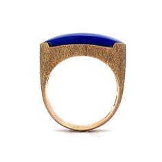 Vibrant Blue Lapis Lazuli! This vintage Mid-Century statement saddle ring features a blue lapis lazuli gemstone in 14 karat yellow gold. Chunky & stylish. The cabochon cut gem resembles the famous Mediterranean blue color in a sleek oval form. The gemstone is set flush on a polished 14 karat yellow gold band. Lapis lazuli have been associated with strength, wisdom, intellect and truth. A one of a kind gift for you or your loved one. Lapis Lazuli Jewelry Rings, Luxury Lapis Lazuli Ring Jewelry, Lapis Stone Ring, Luxury Lapis Lazuli Cabochon Rings, Luxury Cabochon Lapis Lazuli Rings, Luxury Lapis Lazuli Gift Ring, Lapis Lazuli Diamond Ring, Luxury Elegant Lapis Lazuli Rings, Carved Lapis Ring