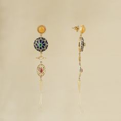 India-inspired, the Firdos earrings are a nod to 1940s Hollywood style, when chandelier earrings were a 'big thing'. These earrings bring together, in harmony, handcrafted units, each unique in themselves. Highlights of the story being an intricately enamelled - diamond studded disc and an ornate pearl strung oval-shaped disc. They are all held together by a bright yellow stud and a push-back closure. Gold(14K) : 9.51gRose-cut Diamonds : 0.95ctGemstone : Emerald, Ruby, Yellow Onyx, Cultured Pear Gold-plated Yellow Gold Earrings With Gemstone Accents, Yellow Gold Earrings With Gemstone Accents For Party, Luxury Pierced Sterling Silver Chandelier Earrings, Luxury Sterling Silver Pierced Chandelier Earrings, Exquisite Yellow Gold Earrings With Gemstone Accents, Sterling Silver Multi-stone Yellow Gold Earrings, Yellow Gold Sterling Silver Multi-stone Earrings, Yellow Gold Multi-stone Sterling Silver Earrings, Yellow Gold Pierced Round Chandelier Earrings