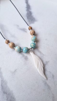 This white feather necklace symbolizes hope and wisdom. It is minimalist and elegant, suitable for every kind of outfit. Handmade with natural healing crystals and high-quality durable materials. This beaded necklace is adjustable in size (slider lock) and lightweight. This can serve as a special gift for yourself or a thoughtful handmade gift for your best friend as a best friend xmas gift.   The healing Jasper gemstone is known for its calming and grounding properties. In all its forms it is c Beaded Necklace White, Boho Beaded Necklace, Sculptural Jewelry, Feather Necklace, White Feather, Feather Jewelry, Handmade Gifts For Her, A Best Friend, Feather Pendant