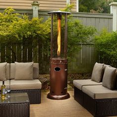 an outdoor patio with furniture and a gas heater