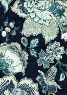 a blue and green floral pattern on fabric