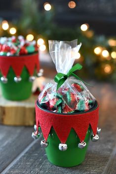 two green and red christmas baskets filled with candy