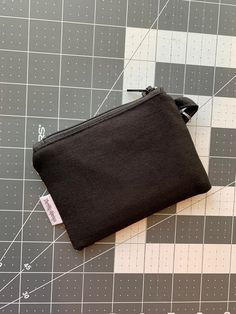 a black pouch sitting on top of a cutting board